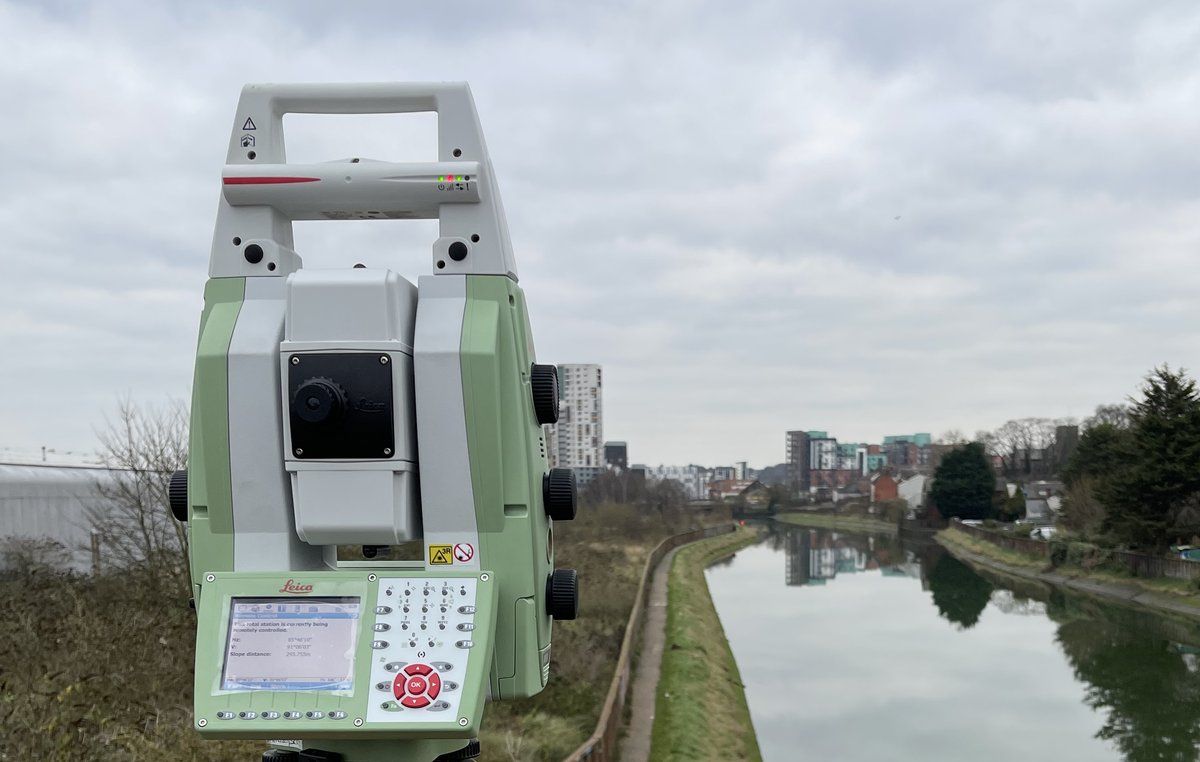 Robotic total station beside a canal